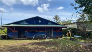 a house with a blue roof at Tumu Cabin Rapa Nui in Hanga Roa