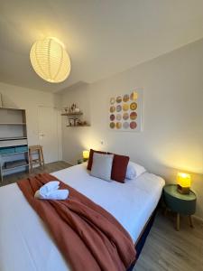 a bedroom with a large bed with two pillows at Le Nantais, centre de Rennes avec garage privé in Rennes