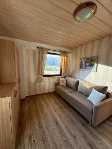 a living room with a couch and a window at Gospodarstwo agroturystyczne U Gazdy in Wisła