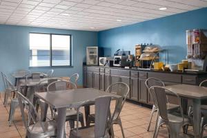 a restaurant with tables and chairs and a counter at Days Inn by Wyndham Neenah in Neenah