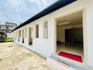 a row of windows on a white building at Nagaon Homestay in Nowgong