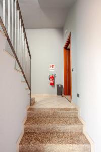 a hallway with stairs and a red fire hydrant at A Home away From Home By Alex in Busto Arsizio