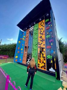a woman standing in front of a play structure at Meadows 33 Hot tub - Southview Holiday Park in Skegness +21 photos