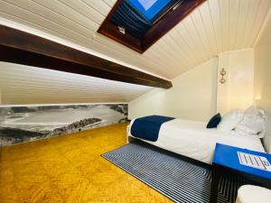 a hotel room with a bed and a window at Alojamento CANTO NA RELVA in Ponta Delgada