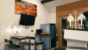 a room with a counter and two tables and chairs at ATTIKO 53 Boutique Rooms in Verona +35 photos