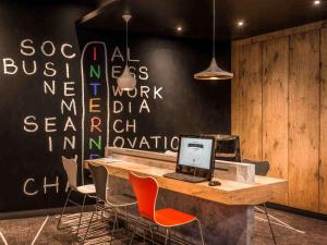 an office with a desk with a computer on it at ibis Paris Montmartre Sacré-Coeur in Paris