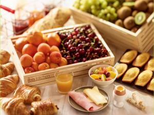 a table topped with lots of different types of food at ibis Paris Montmartre Sacré-Coeur in Paris