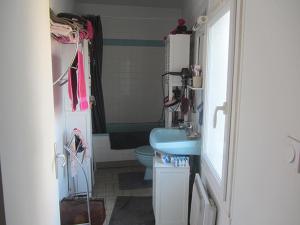 a bathroom with a blue sink and a toilet at Chez Annie Chambre chez l'habitant in Distré