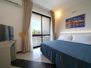 a hotel room with a bed and a television at Hotel Club Clorinda nuova gestione 2024 in Paestum +63 photos