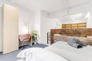 a bedroom with a large white bed and a desk at Beautiful Lofts in Downtown Montreal in Montréal