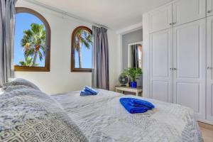 a bedroom with a bed with blue towels on it at Oasis Royal in Corralejo +42 photos