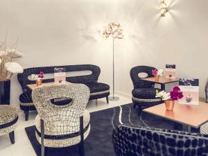 a room with chairs and tables in a store at Mercure Paris Place d'Italie in Paris