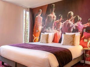 a bedroom with a large bed with a large painting on the wall at Mercure Paris Place d'Italie in Paris