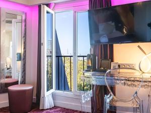 a room with a large window with a view of the city at Mercure Paris Place d'Italie in Paris