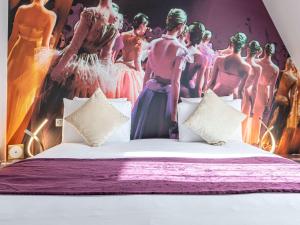 a bedroom with a bed with a painting of women in dresses at Mercure Paris Place d'Italie in Paris