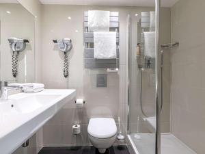a bathroom with a toilet and a sink and a shower at Mercure Paris Place d'Italie in Paris