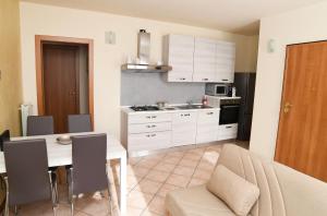 a kitchen with a table and a dining room at Rovato entire apartment in the capital of Franciacorta in Rovato