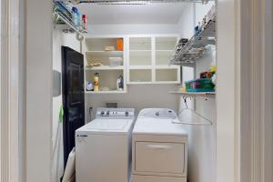 a small kitchen with a stove and a washer at Anderson Place in Savannah +22 photos