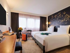 Postel nebo postele na pokoji v ubytování Mercure Paris La Défense
