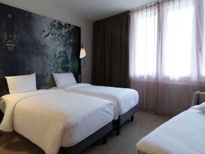 Postel nebo postele na pokoji v ubytování Mercure Paris La Défense