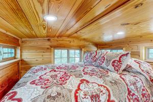 a bedroom with a bed in a wooden cabin at Red Cabin on the Ranch in Harper
