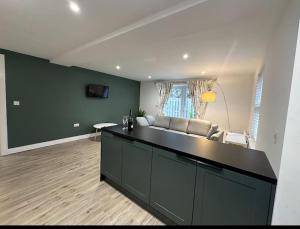 a living room with a couch and a table at Gorgeous 2 bed apartment with free parking near, Sefton Park, Palm House, Lark Lane, Liverpool and Everton football clubs in Liverpool