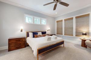 a bedroom with a bed and a ceiling fan at The Ocean Hideaway in Seabrook Island