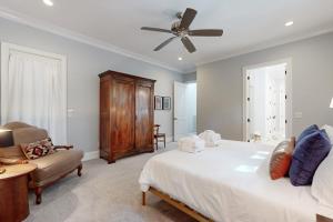 a bedroom with a bed and a ceiling fan at The Ocean Hideaway in Seabrook Island +17 photos