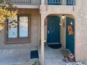 a front door of a house with a blue door at Desert Oasis at Sports Village- Unit W4 in St. George +40 photos