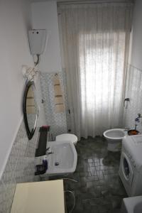 a bathroom with a sink and a toilet and a mirror at Vacanze Romane in Rome +25 photos