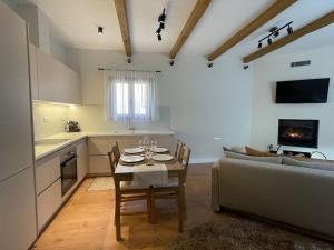 a kitchen and living room with a table and a couch at Trifonakia in Vitina