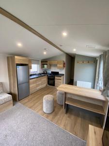 a large kitchen with a table and a counter top at 3 Bedroom - Stunning Caravan in Coastal Eyemouth in Eyemouth
