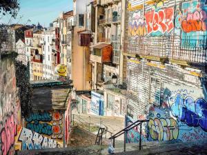 a group of buildings with graffiti on them at Mercure Porto Centro Santa Catarina in Porto