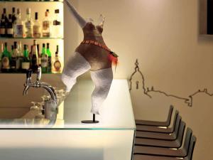 a figurine of a woman standing on top of a counter at Mercure Porto Centro Santa Catarina in Porto