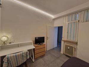 a room with a desk and a tv in it at La dimora del Conte in Trento