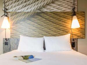 Cama ou camas em um quarto em ibis Genève Aéroport
