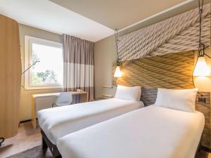 Cama ou camas em um quarto em ibis Genève Aéroport