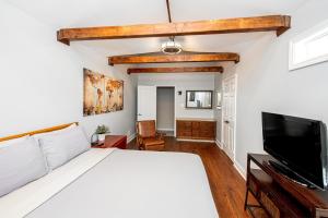 a bedroom with a bed and a flat screen tv at 3BR Charlotte Escape Pool Hot Tub Theater in Charlotte