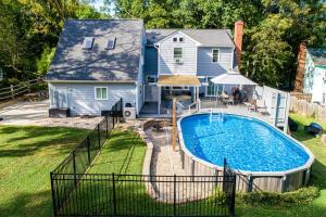 a backyard with a swimming pool and a house at 3BR Charlotte Escape Pool Hot Tub Theater in Charlotte