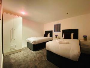a hotel room with two beds in a room at Callerton House in Newcastle upon Tyne