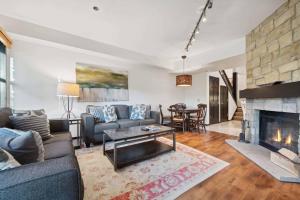 a living room with a couch and a fireplace at Woodrun Place 36 in Snowmass