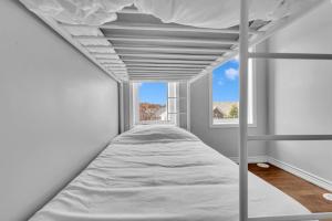 a bedroom with a bunk bed with a window at Cozy 3BR Home with Parking Near Kitchener Attractions in Kitchener