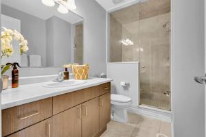 a bathroom with a sink and a toilet and a shower at Cozy 3BR Home with Parking Near Kitchener Attractions in Kitchener +34 photos