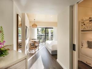 a bedroom with a bed and a table in a room at Sofitel Fiji Resort & Spa in Denarau