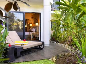 a patio with a bench and some plants at Sofitel Fiji Resort & Spa in Denarau