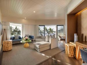 a living room with a couch and a chair at Sofitel Fiji Resort & Spa in Denarau