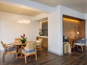 a dining room and kitchen with a table and chairs at Sofitel Fiji Resort & Spa in Denarau