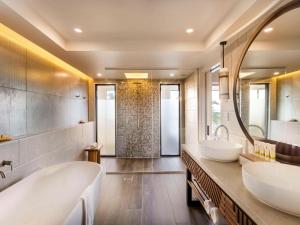 a bathroom with two sinks and a shower at Sofitel Fiji Resort & Spa in Denarau