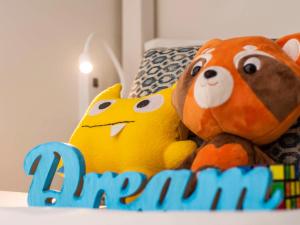 two stuffed animals are sitting on a bed at Sofitel Fiji Resort & Spa in Denarau