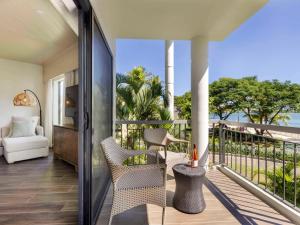 a balcony with a view of the ocean from a house at Sofitel Fiji Resort & Spa in Denarau